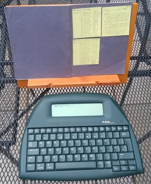 With a bookrest, I can easily type up notes on the AlphaSmart Neo while sat at the patio table on a sunny day.